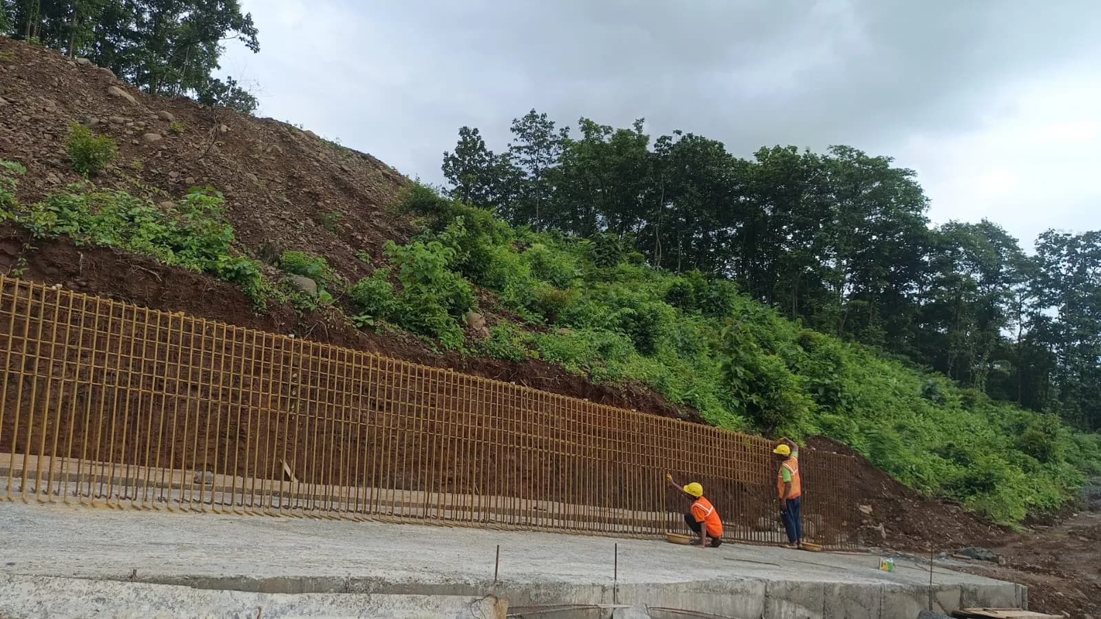 Crew in safety gear building a retaining wall on the Durshet hillside